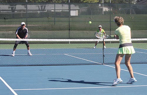 Mixed doubles on tennis court