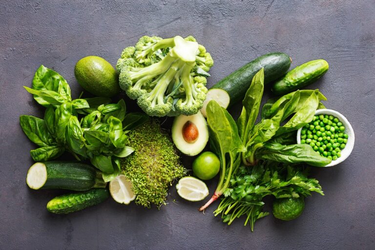 Set raw healthy food clean eating vegetables source of protein for vegetarians: cucumber, lucerne, zucchini, spinach, basil, green peas, avocado, broccoli, lime on black background, top view